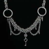 a silver chain necklace with a key and heart