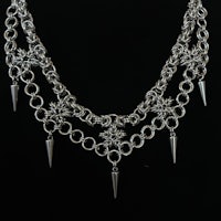 a silver necklace with spikes and spikes