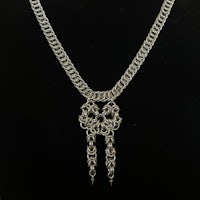 a silver chain necklace on a black background